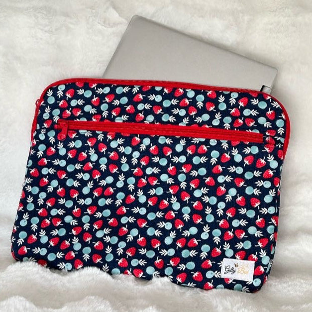 Fabric pouch withstrawberry fabric with a red zipper, a zipper pocket and a visible Gilly Bee Logo
