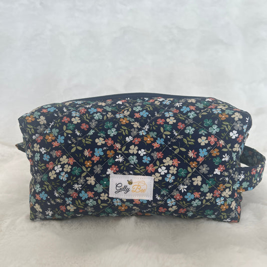 Floral quilted carry all pouch with a visible gilly bee brand label on a white background