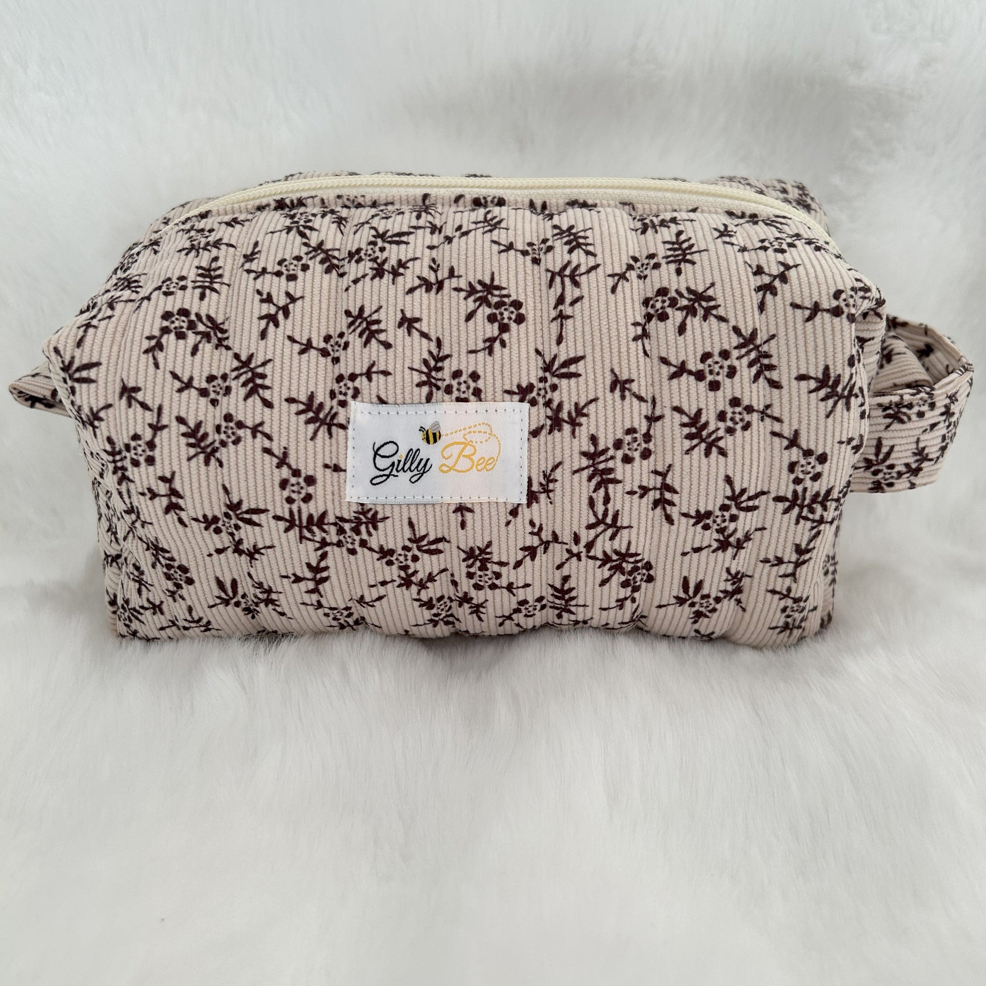 Autumn leaves fabric on a quilted pouch with a visible Gilly Bee brand label 