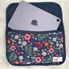 Floral patterned pouch with a ipad inside on a white background