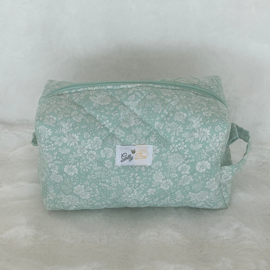 Green floral-Liberty patterned makeup pouch with a Gilly Bee brand label on a white background