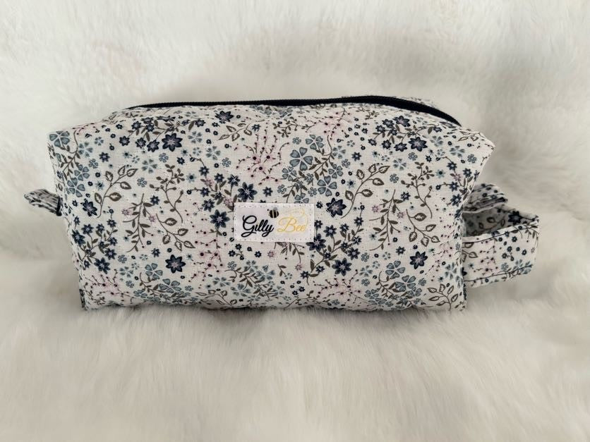Floral-patterned pouch with a visible Gilly Bee brand logo on a white background