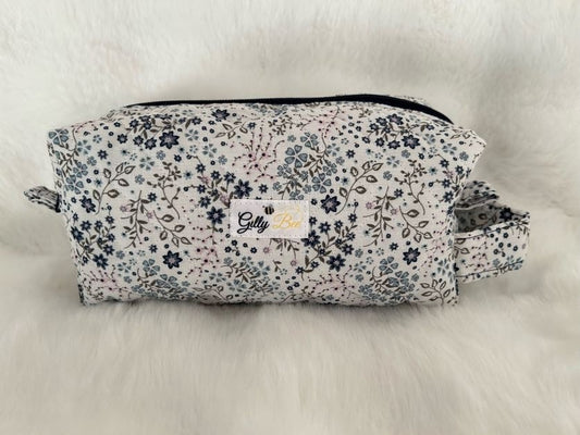 Floral-patterned pouch with a visible Gilly Bee brand logo on a white background