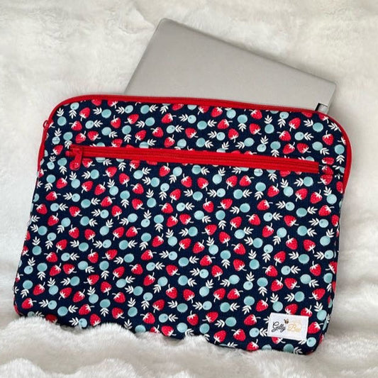 Fabric pouch withstrawberry fabric with a red zipper, a zipper pocket and a visible Gilly Bee Logo