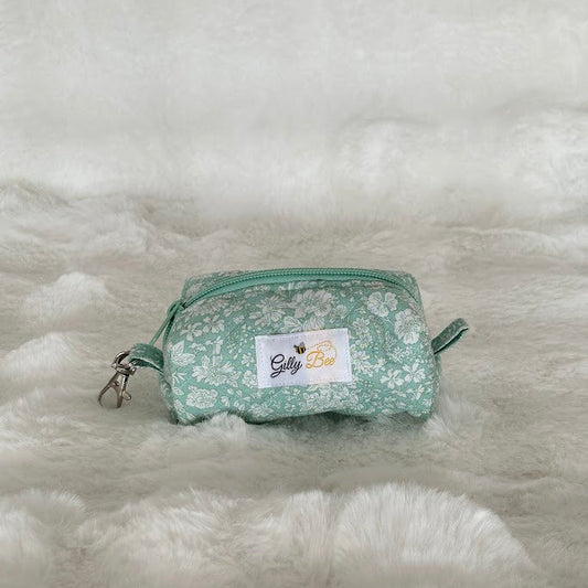 Green floral key chain pouch with a gilly Bee label on a white surface