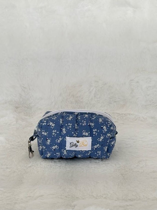 Blue floral-patterned key chain pouch with a white Gilly Bee brand label on a white background